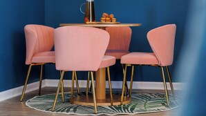 A dining area with a round table, pink chairs, a hanging light fixture, and a neon sign reading "tampa tropics". - A Boho City Escape  Sleeps 8 Tampa Heights (Tampa)