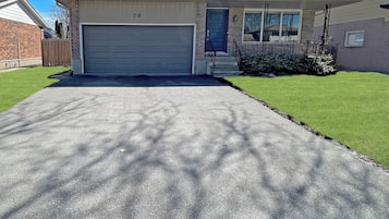A single-story house with a garage, a front door, and a small front yard.