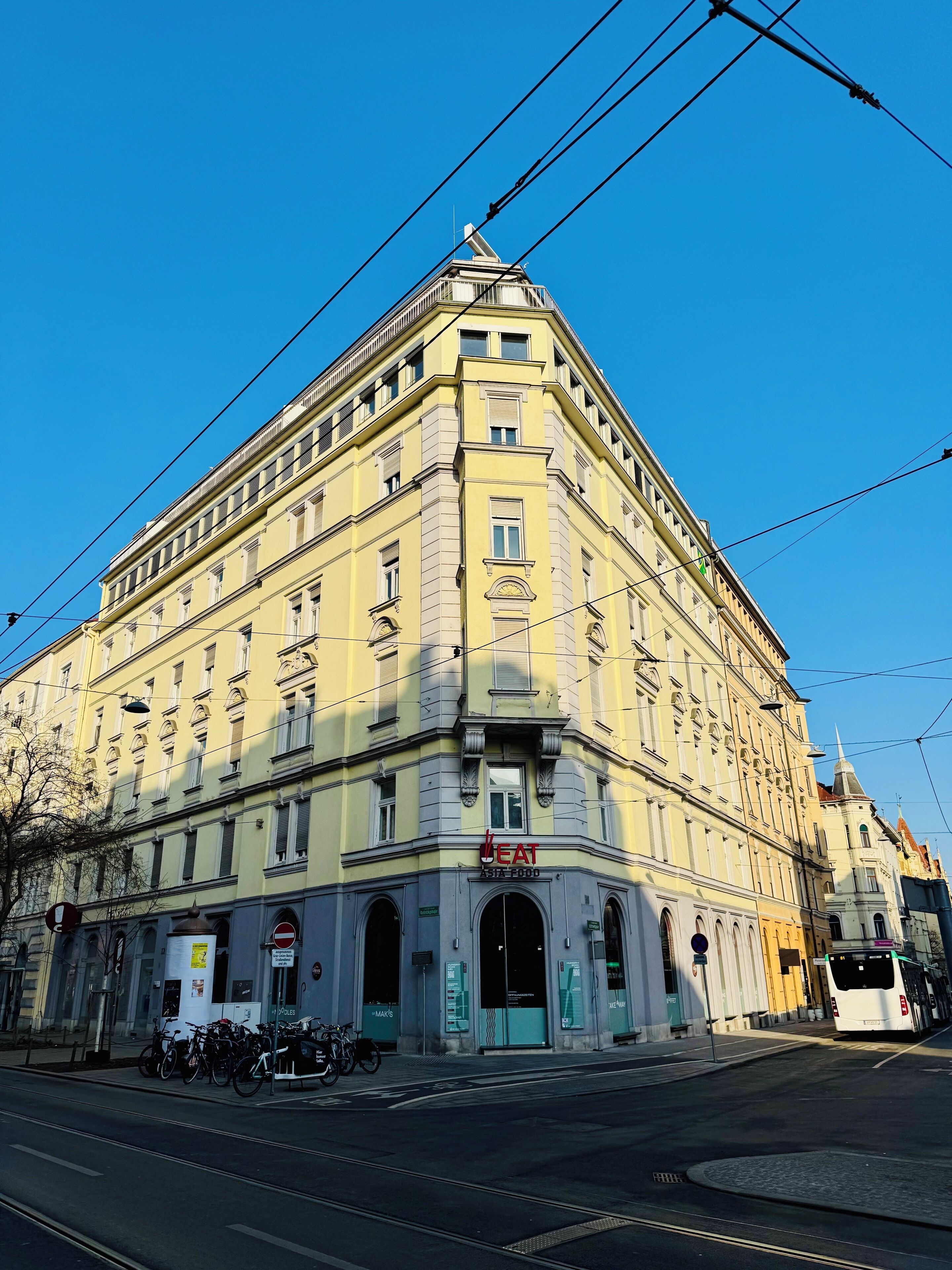 A historic building with a corner entrance, multiple windows, and a sign for a restaurant.