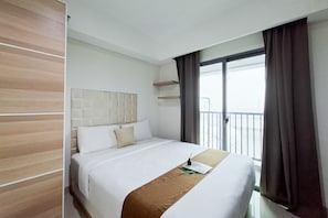 A hotel room with a bed, a headboard, a window with curtains, and a balcony. - Comfortable 1Br Without Living Room At Apartment Bintaro Embarcadero (South Tangerang)
