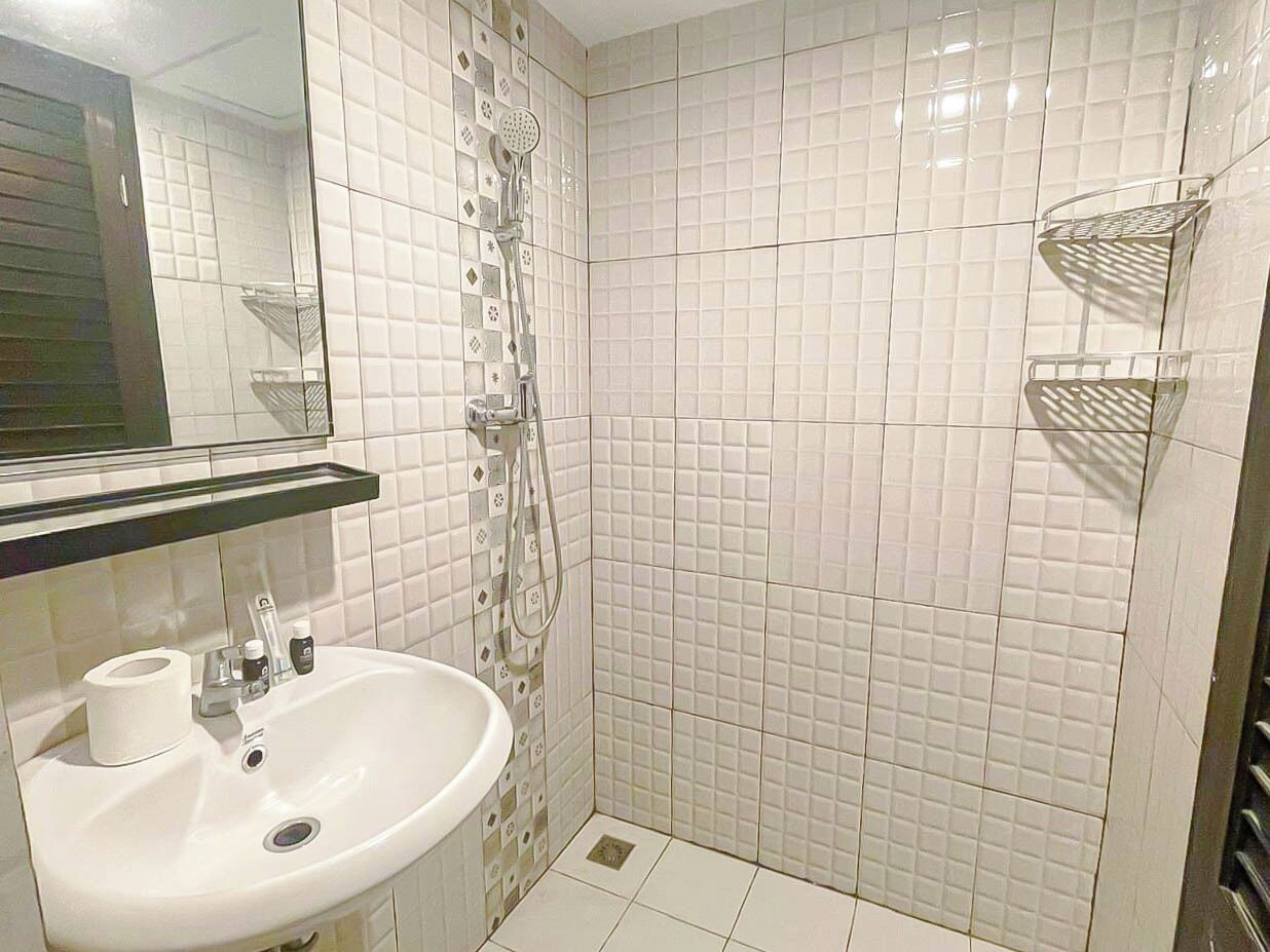 A bathroom with a sink, toilet, and shower.