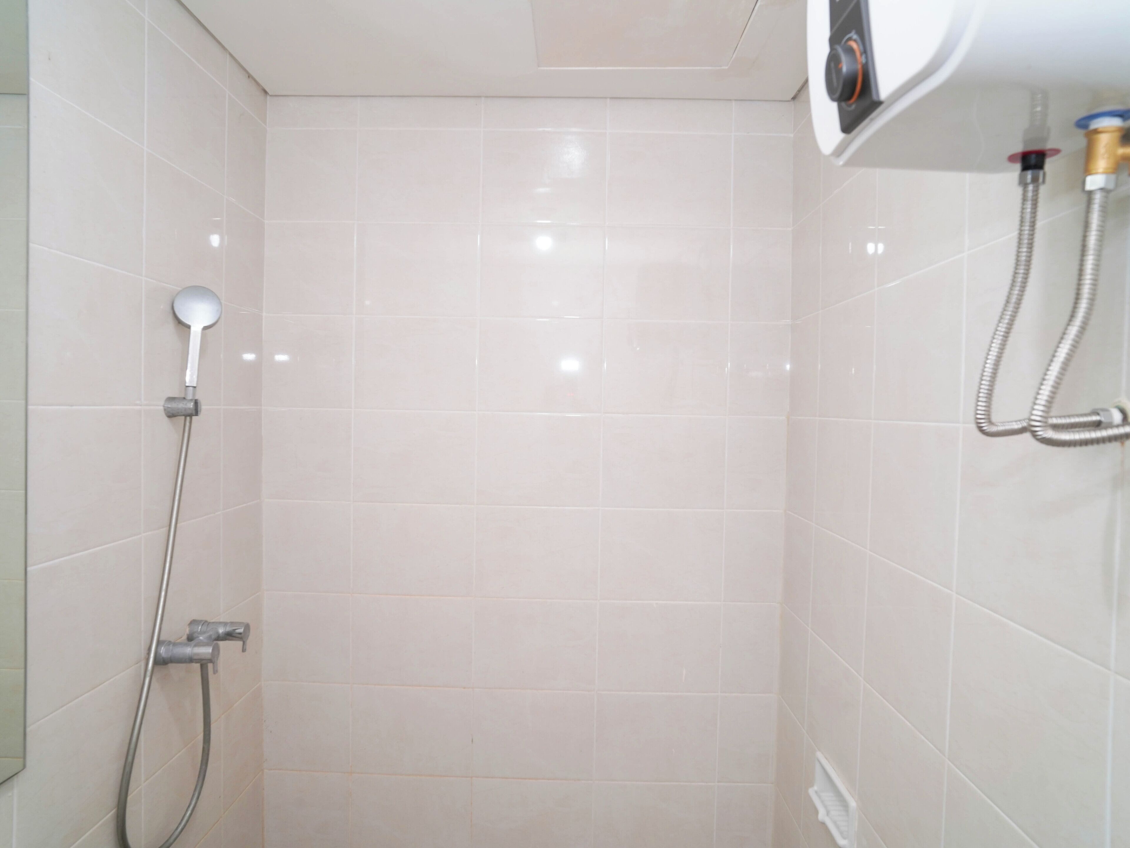 A bathroom with a shower, a toilet, and a sink.