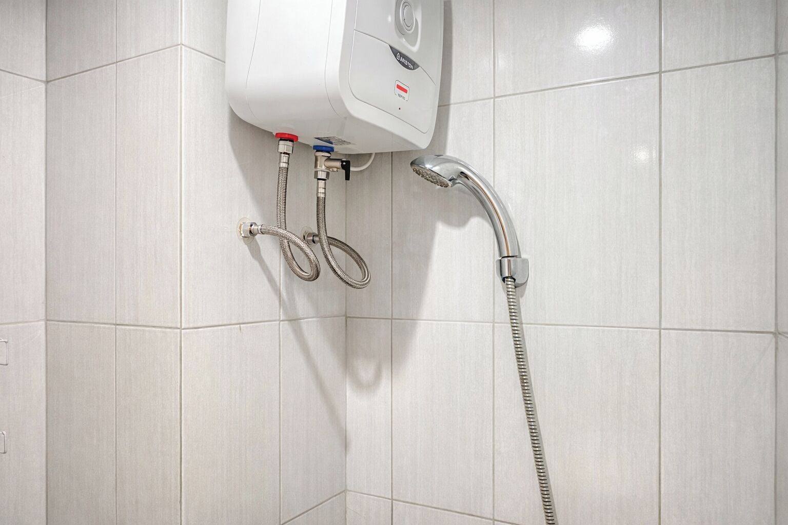 A modern bathroom with a wall-mounted shower unit, a handheld showerhead, and a control panel.