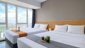 A hotel room with two beds, a city view, a wooden headboard, and a small plant on the bedside table. - Comfy 2Br For 6 Pax At Nifarro Park Apartment (Jakarta)