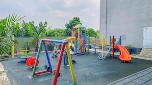 A playground with various play structures including swings, slides, and climbing areas. - Wonderful Studio At Apartment Nifarro Park Near Pasar Minggu Station (Jakarta)