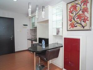 Dining room - Serene Red Vibe 2Br At Apartment Nifarro Park (Jakarta)