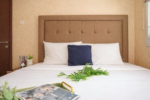 A hotel room with a large bed, a headboard, a nightstand, a window, and a door. - Good Location 1Br At Apartment Signature Park Grande (Jakarta)