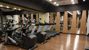 A gym with multiple treadmills and exercise equipment. - Damask Style Studio At Signature Park Grande Apartment (Jakarta)