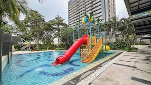 A water park with a red slide, a yellow and blue ball pool, and a water play area. - Spacious And Lavish 4Br At The Via And The Vue Ciputra World Apartment (Surabaya)