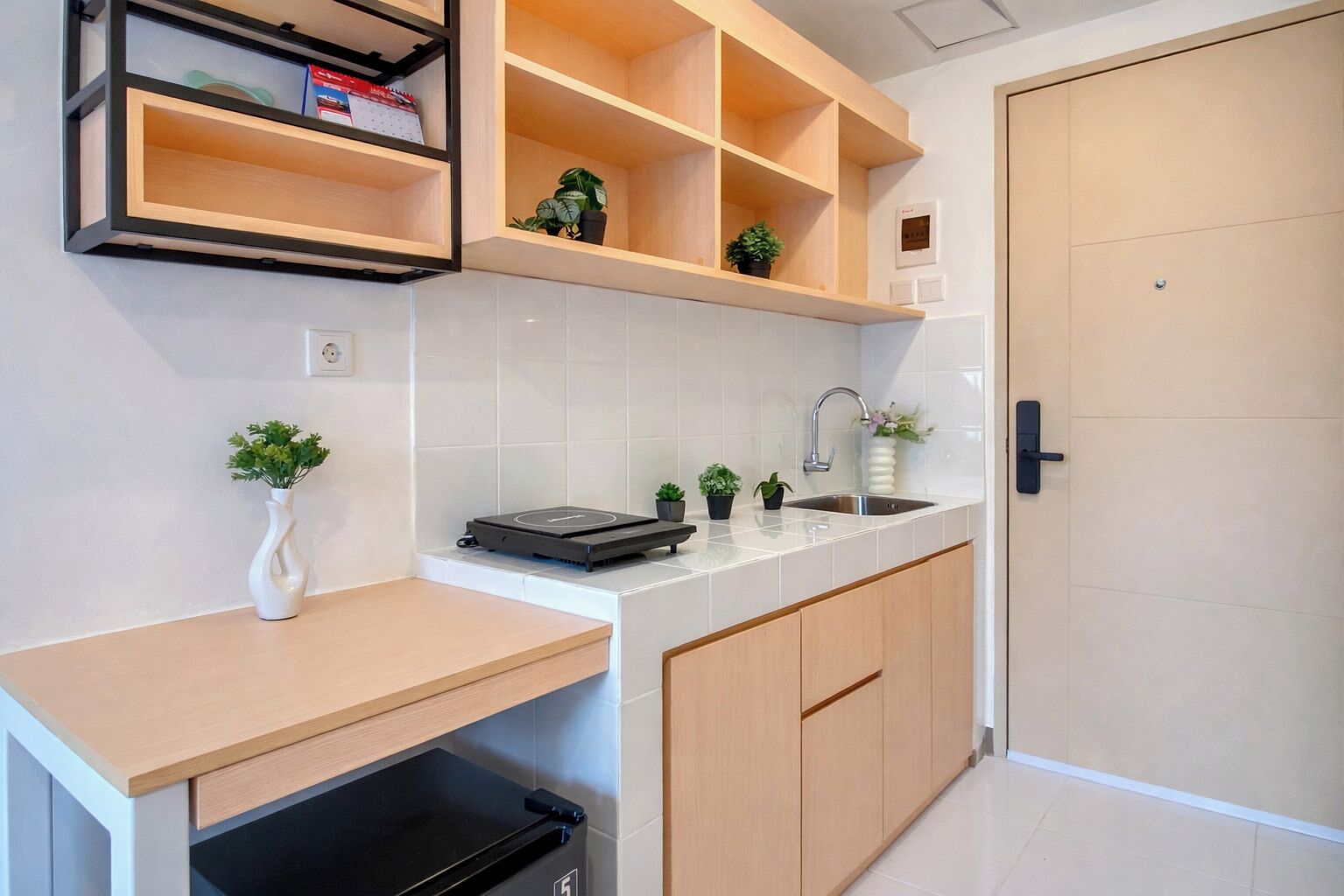 A modern kitchen with a built-in oven, a sink, and a countertop.