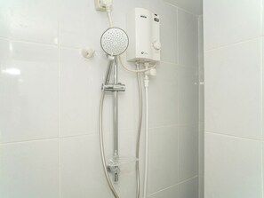 A shower with a handheld showerhead and a wall-mounted control panel. - Strategic And Stylish Studio At Apartment Tokyo Riverside Pik 2 (Teluknaga)