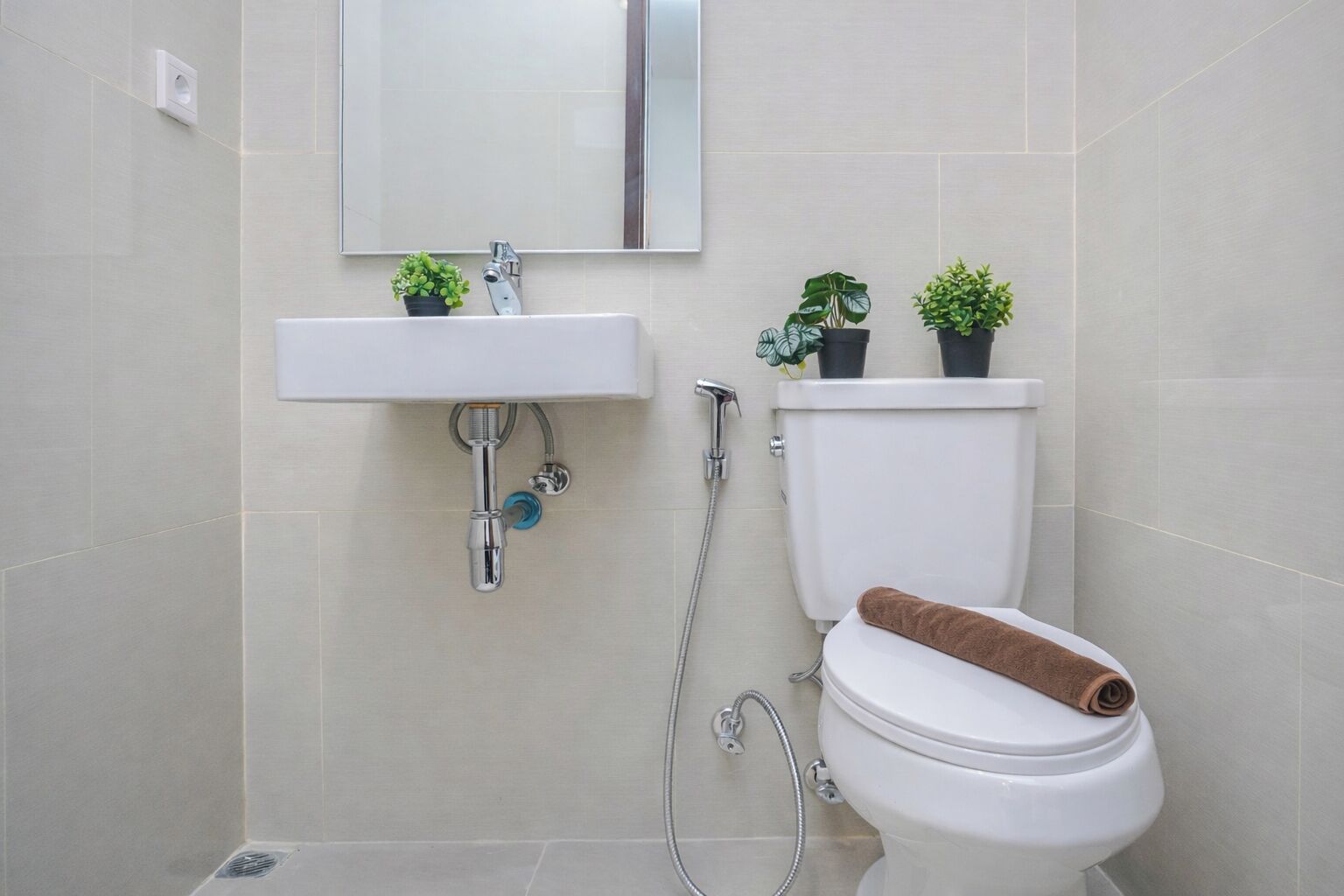 A bathroom with a white sink, a toilet, and a shower.