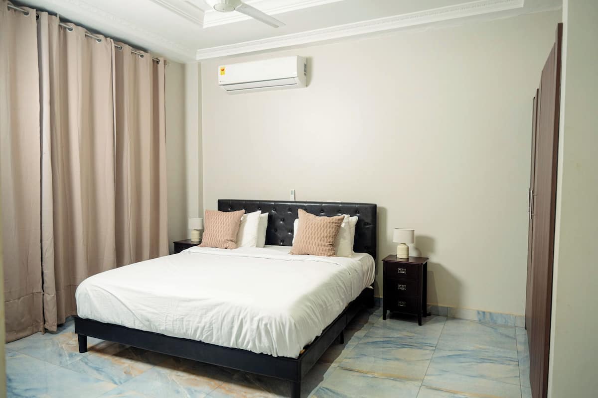 Premium bedding, desk, laptop workspace, blackout drapes