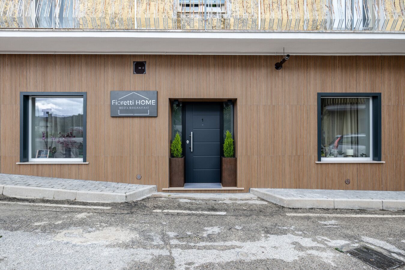 Een modern gebouw met een bord waarop staat 'Fioretti HOME BED & BREAKFAST'.
