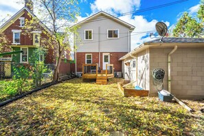 A two-story house with a fenced backyard, a satellite dish, and a hose reel. - Walkable to DT | Suits Large Grps | 2 Parking spot (Kitchener)