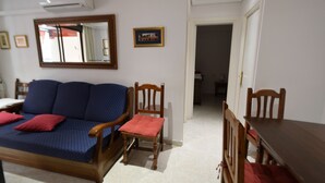 A room with a sofa, chairs, a dining table, a mirror, and a framed picture on the wall. - LAS Tejas 2-31 in Benidorm (Benidorm)