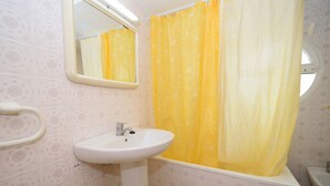 A bathroom with a white sink, a mirror, and a yellow shower curtain. - Caballos 14H in Benidorm (Benidorm)