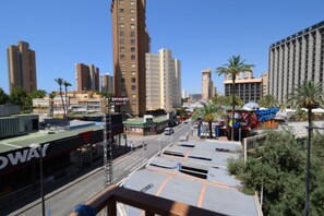 A cityscape with high-rise buildings, a street with vehicles, and a building with a visible sign. - Oce3 3A in Benidorm With 2 Bedrooms and 1 Bathrooms (Benidorm)