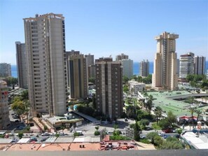 A high-rise building complex with multiple residential towers, a sports field, and a parking area. - Gemelos 2 11e2 in Benidorm (Benidorm)