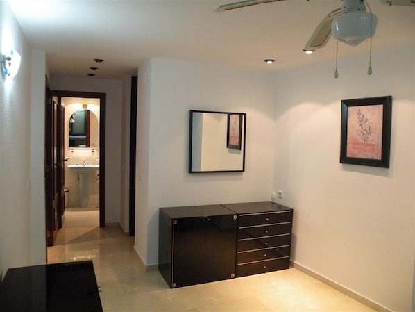 A hallway with a black cabinet, a mirror, and a framed picture on the wall. - Gemelos 11 6C1 in Benidorm (Benidorm)