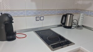 A kitchen with a coffee maker, kettle, and a coffee station. - Villamarina A517 in Benidorm (Benidorm)