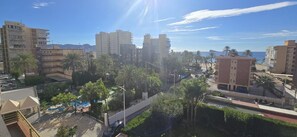A coastal cityscape with high-rise buildings, palm trees, and a clear sky. - Castelmar 1C in Benidorm (Benidorm)