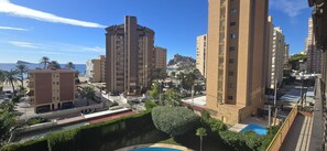 A high-rise building with multiple floors, a swimming pool, and a view of the sea. - Castelmar 1C in Benidorm (Benidorm)