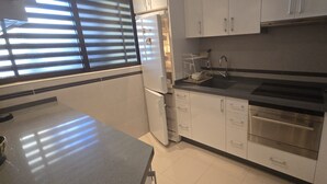 A kitchen with a refrigerator, sink, oven, and cabinets. - Castelmar 1C in Benidorm (Benidorm)