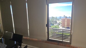 A room with a large window, a chair, and a table. - Castelmar 1C in Benidorm (Benidorm)