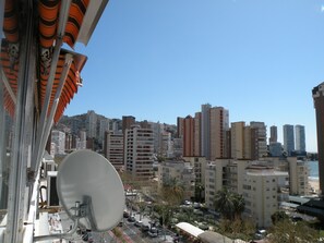 A cityscape with high-rise buildings, a clear sky, and a satellite dish on a balcony. - Ducado 8D in Benidorm (Benidorm)