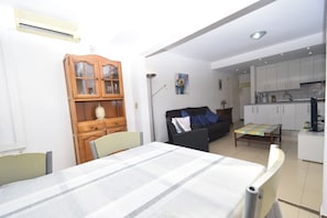 A compact living space with a bed, a dining table, a sofa, a cabinet, and a kitchenette. - Gemelos 5 4C in Benidorm (Benidorm)