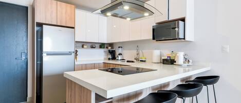 Family Suite, City View | Private kitchen | Full-sized fridge, microwave, stovetop, griddle
