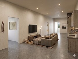 A spacious living room with a large flat-screen TV, a sofa, and a fireplace.
