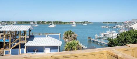 A marina with boats docked, wooden walkways, and a clear view of the water.