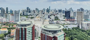 A cityscape with modern buildings, including a prominent circular structure labeled "CHATRIUM". - Central Bangkok New Condo  · Walk to Siam Paragon (Bangkok)