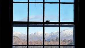 A window with a view of snow-covered mountains and a lake. - Walk to Main Street & Mirror Lake (Lake Placid)