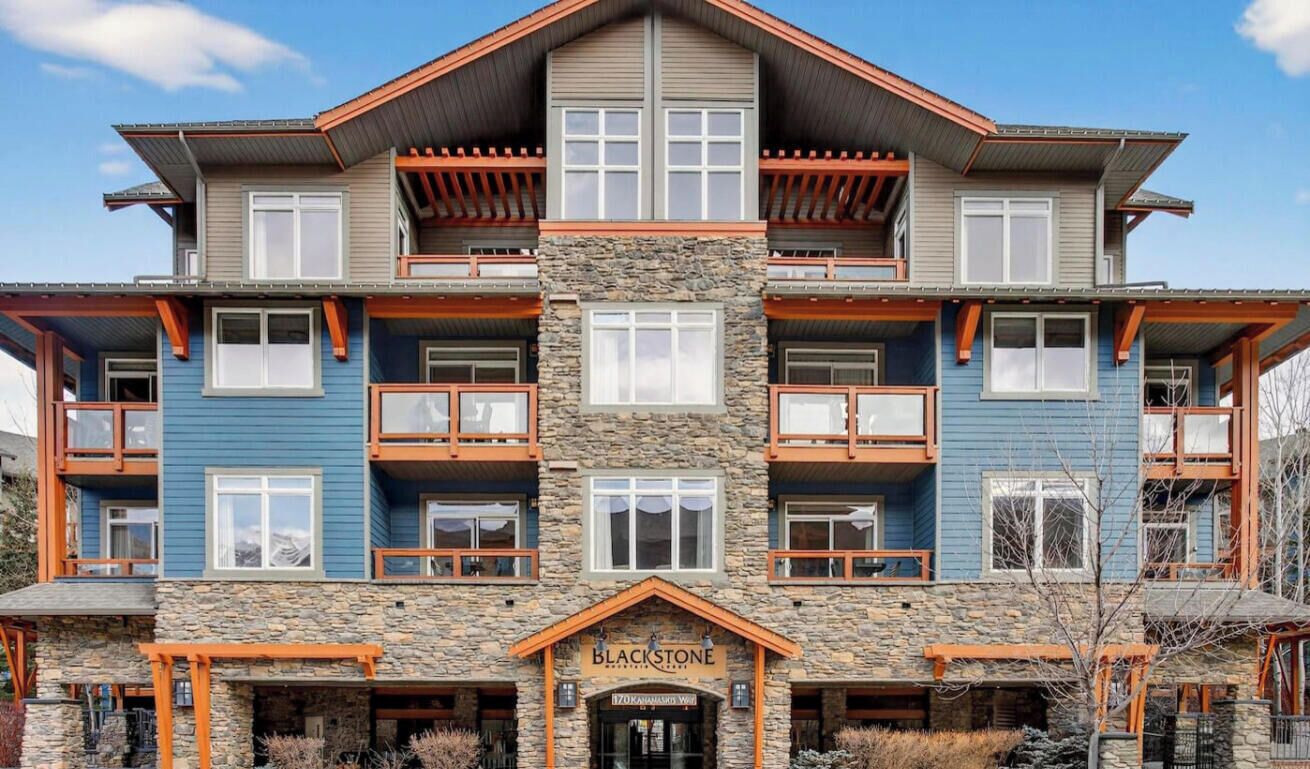 Un immeuble à plusieurs étages, doté d’une façade en pierre, de nombreux balcons et d’une entrée bien visible, portant l’inscription « Blackstone ».