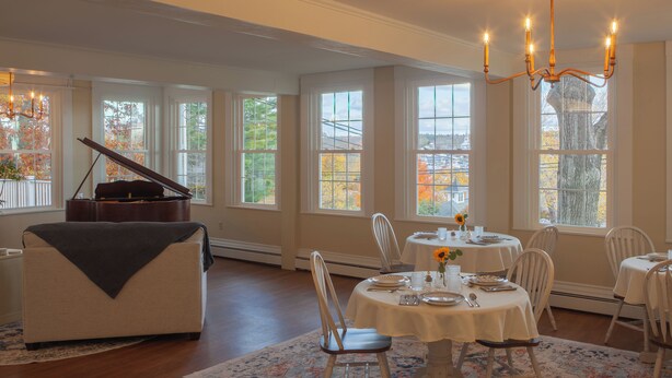 A dining area with a piano, large windows, and a chandelier. - Graceful and inviting, The Serenity Garden Suite
No Cleaning Fee (Newcastle)