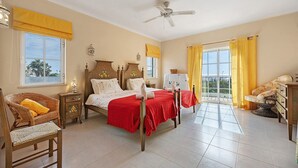 A bedroom with a bed, a chair, a nightstand, a dresser, and a ceiling fan. - Villa 'Monte Lemos  35' with Sea View, Wi-Fi and Air Conditioning (Luz)