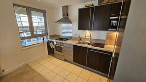 Fridge, microwave, oven, stovetop - Buckler Court Islington 2‑Bed Kings Flat (Greater London)