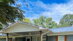 A single-story house with a covered porch, a front door, and a small front yard. - Family Friendly home down from the lake, just minutes to a dock and downtown! (Guntersville)