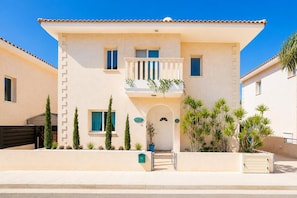 A two-story building with a balcony, a small garden, and a mailbox. - Villa Chromata - Three Bedroom Villa, Sleeps 7 (Pernera)