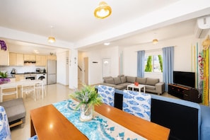 A modern apartment with a kitchen, dining area, living room, and a TV. - Villa Chromata - Three Bedroom Villa, Sleeps 6 (Pernera)