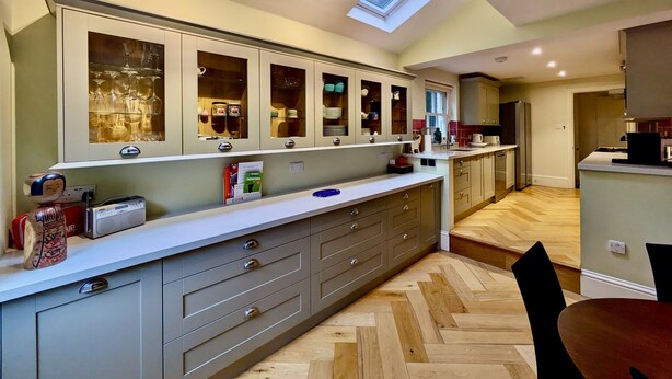 A modern kitchen with built-in cabinets, a central island, and skylights. - Stunning Family Home in Tulse Hill (London)