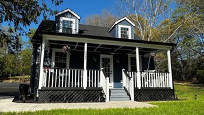 A two-story house with a porch, a small upper deck, and a number '2040' on the front. - Charming 3-bedroom completely remodeled country house in Tappahannock with AC (Tappahannock)