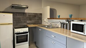 A modern kitchen with a white refrigerator, a stove, and a microwave. - Modern apartment with country view - 2 guests (Le Vernet)