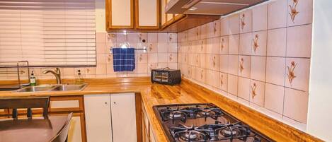 Gas stove with a large countertop, perfect for cooking with ease.