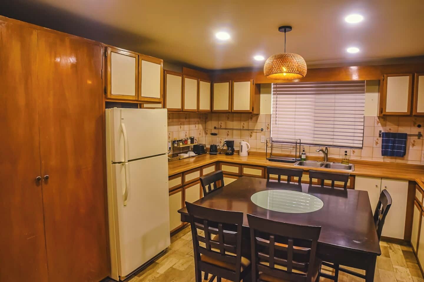 Elegant dining area with wooden table and warm lighting, perfect for meals, remote work, or relaxed conversations.