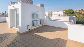 A rooftop terrace with a white exterior, air conditioning units, and a clear view of the cityscape. - Modern house in Altafulla, near beach, 6 people (Altafulla)