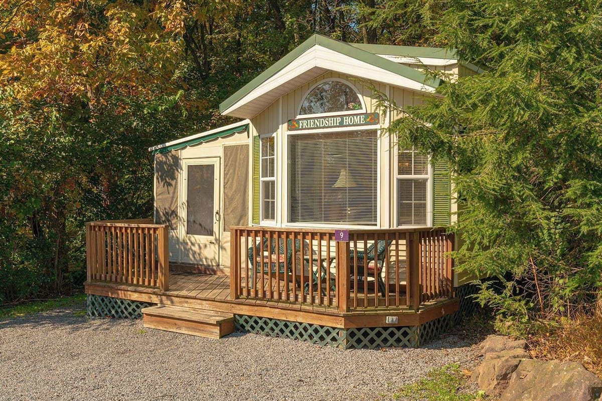 A small, single-story cabin labeled 'Friendship Home' with a porch and a door.